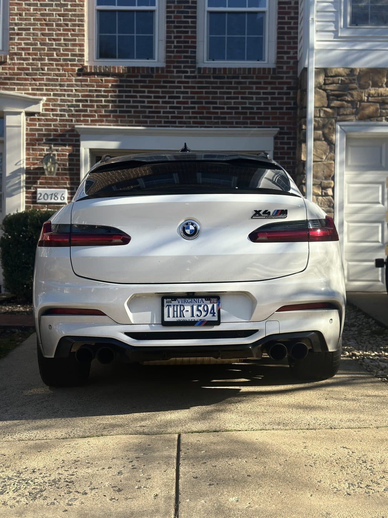 White BMW X-series SUV in driveway, BMW service DMV