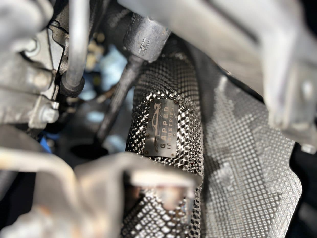 Underbody heat-shield detail during service, auto repair Northern Virginia
