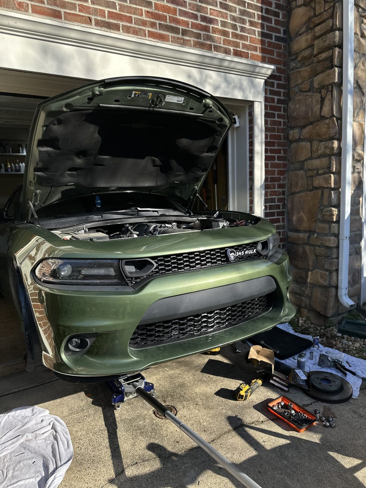 Green Dodge Charger front-end repair in driveway, auto repair Sterling VA