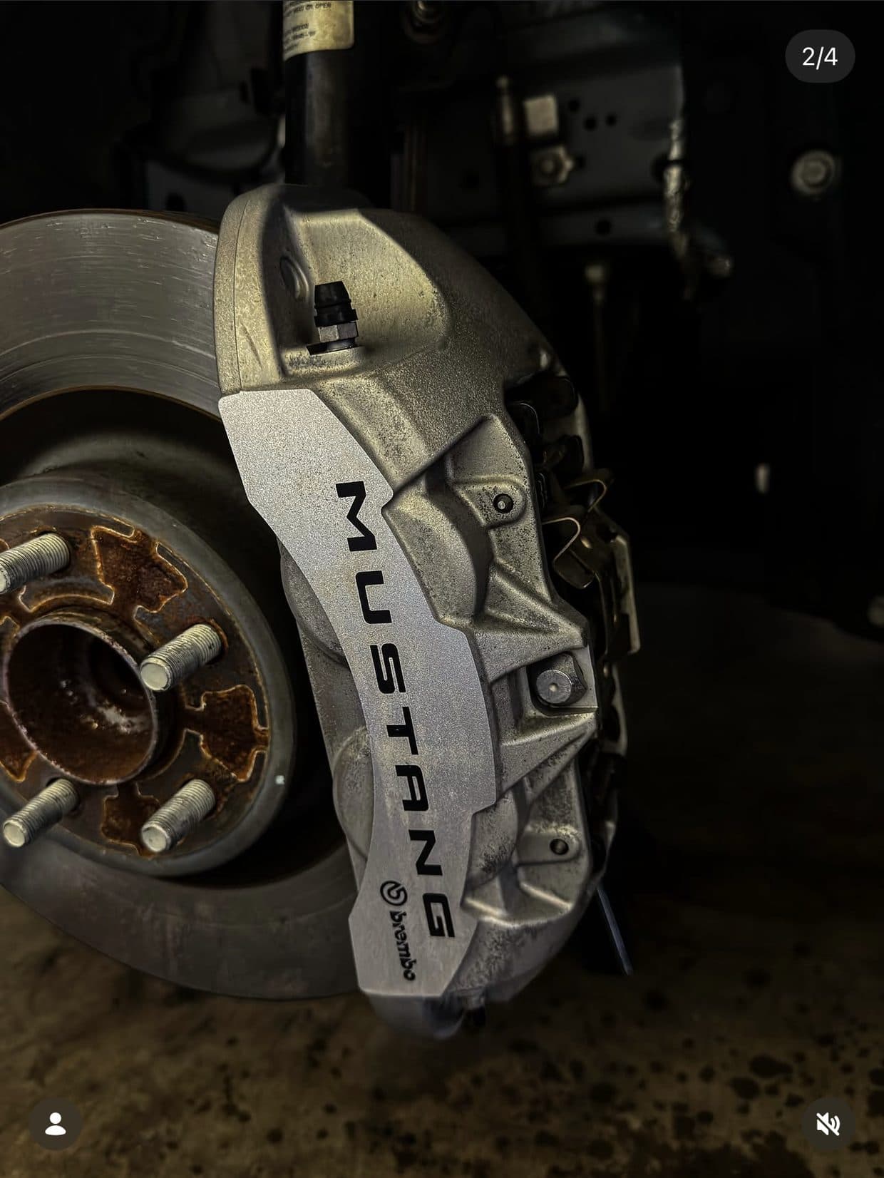 Mustang S650 silver Brembo caliper before reflective yellow vinyl wrap